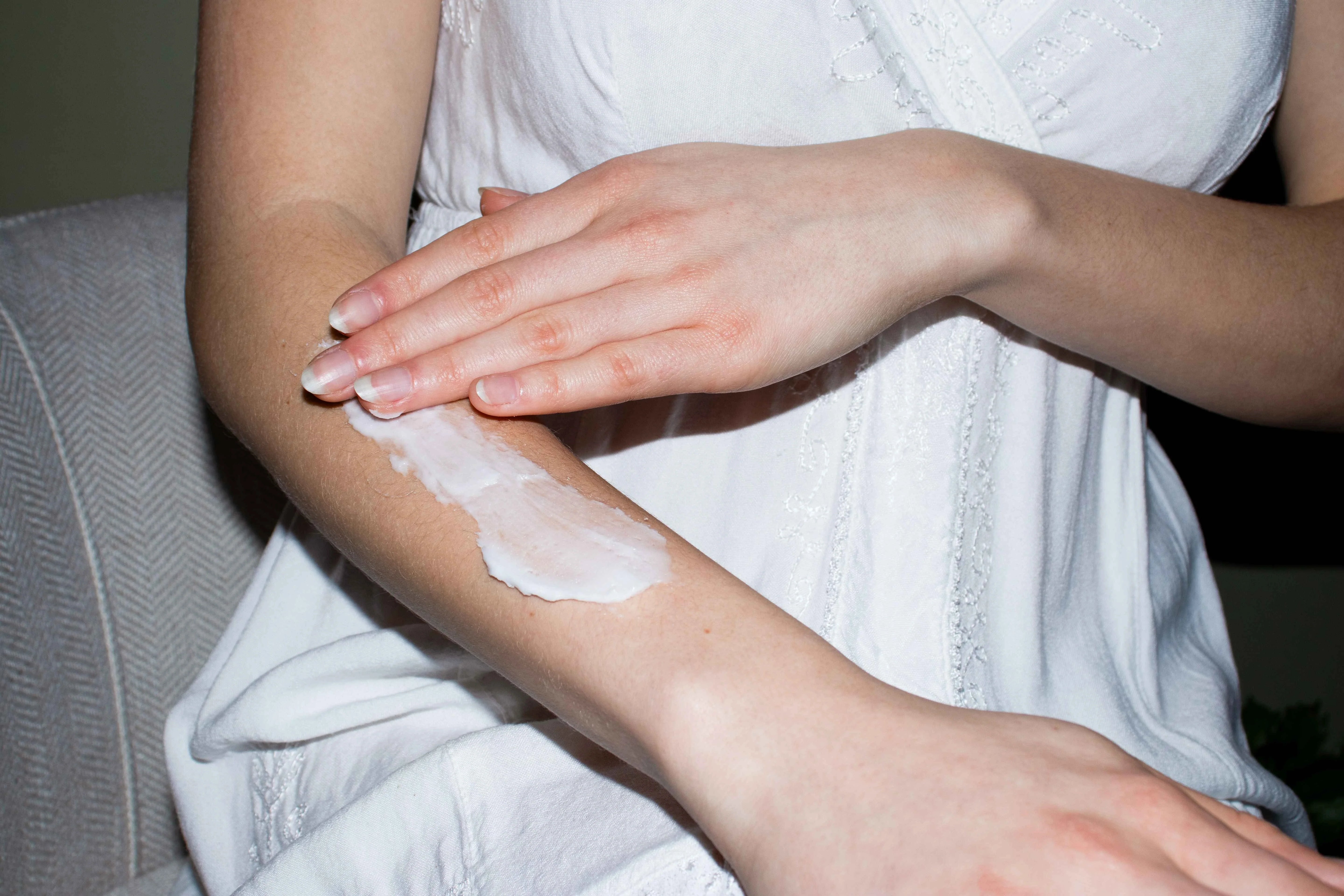 Girl rubbing Grass-Fed Tallow Body Butter on her arm
