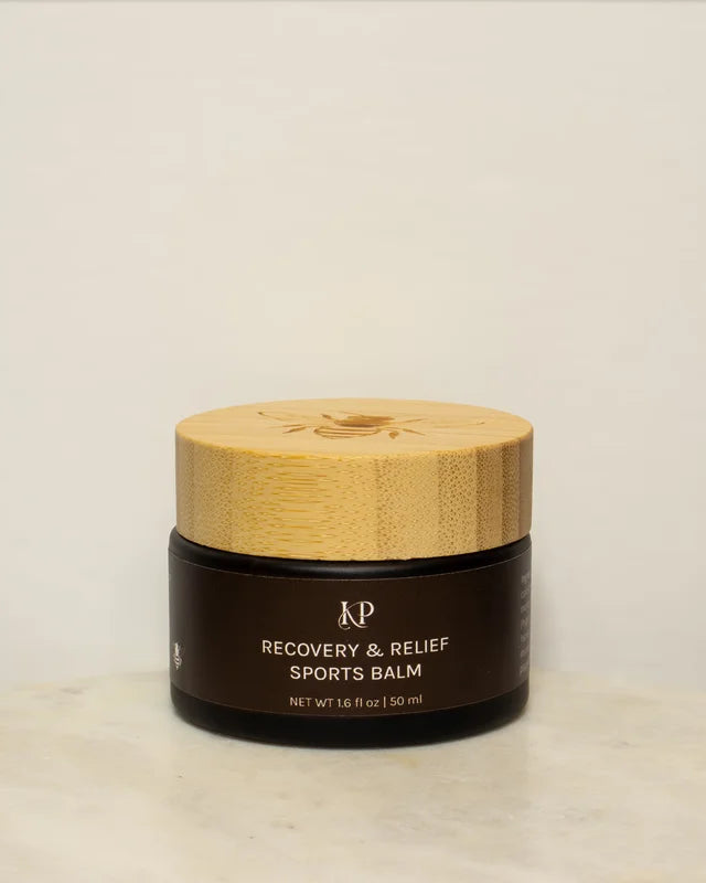 Sports balm jar with wooden lid on a marble surface